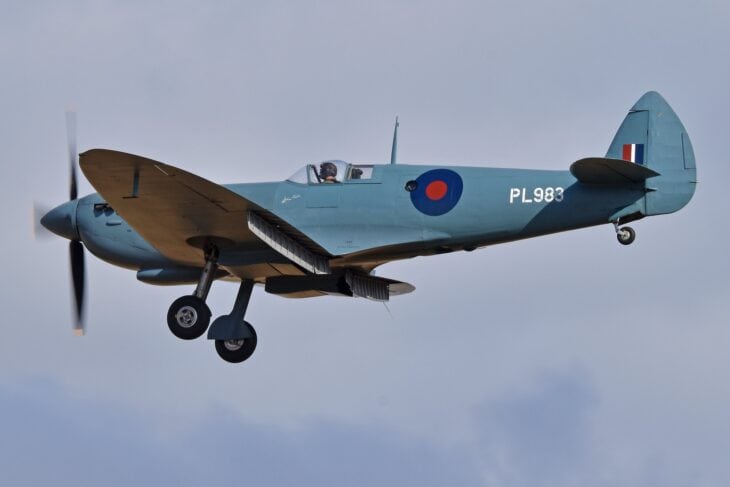 Blue Supermarine Spitfire PR.XI PL983 in flight with landing gear lowered