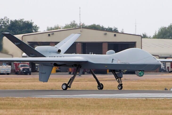 General Atomics MQ-9B SkyGuardian uncrewed aircraft on a runway after landing, with its long wings and ventral sensor turret visible