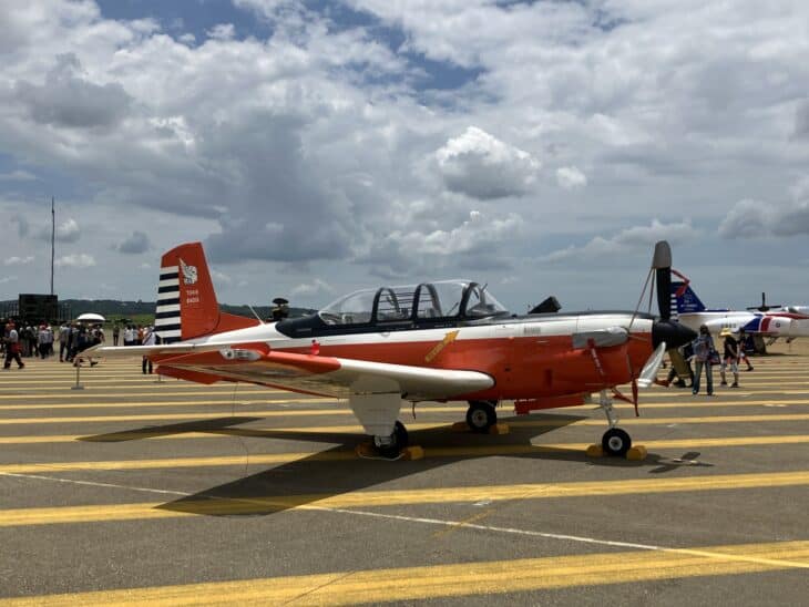 Republic of China Air Force Beechcraft T-34C Turbo Mentor trainer, serial 3415, in red and white markings on an airfield apron