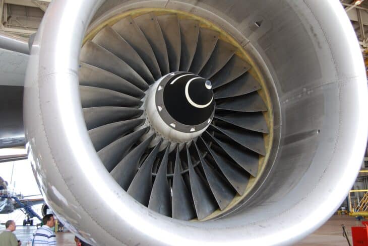 Close-up of the large fan blades and spinner inside the intake of a Rolls-Royce Trent turbofan on an American Airlines Boeing 777-200