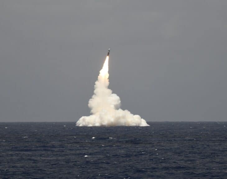 An unarmed Trident II D5 ballistic missile rising from the sea after launch from a submerged Ohio-class submarine
