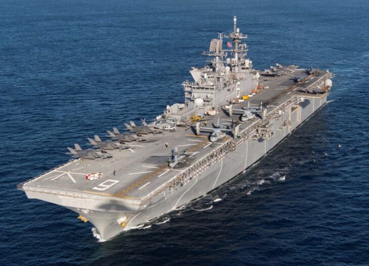 Aerial view of the amphibious assault ship USS America underway with F-35B Lightning II jets parked on its flight deck