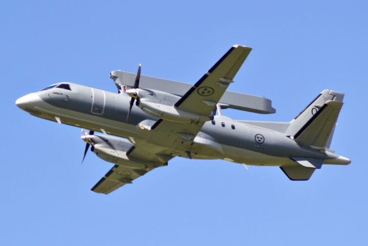 A Saab 340 airborne early warning aircraft taking off, the Erieye radar beam mounted along the top of its fuselage