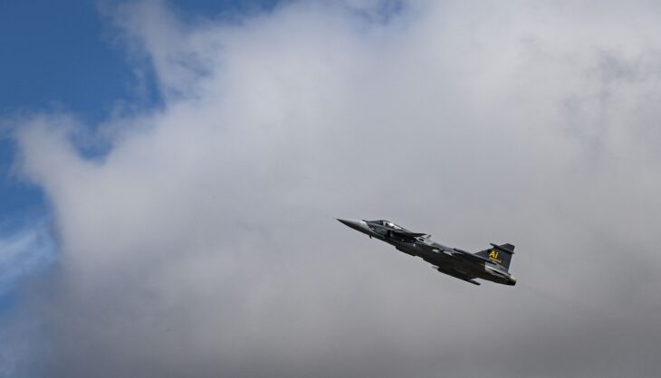 A Swedish Air Force Saab JAS 39E Gripen climbing against a cloudy sky