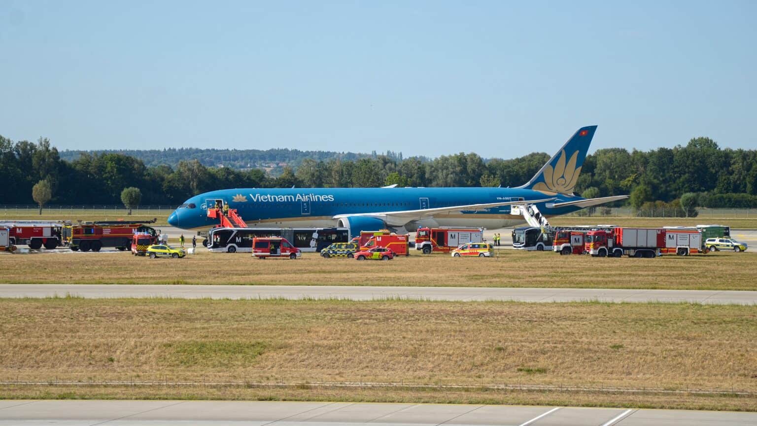 Vietnam Airlines Boeing 787-9 VN-A867 on the ground at Munich Airport with fire trucks, boarding stairs and buses around it on August 15, 2026