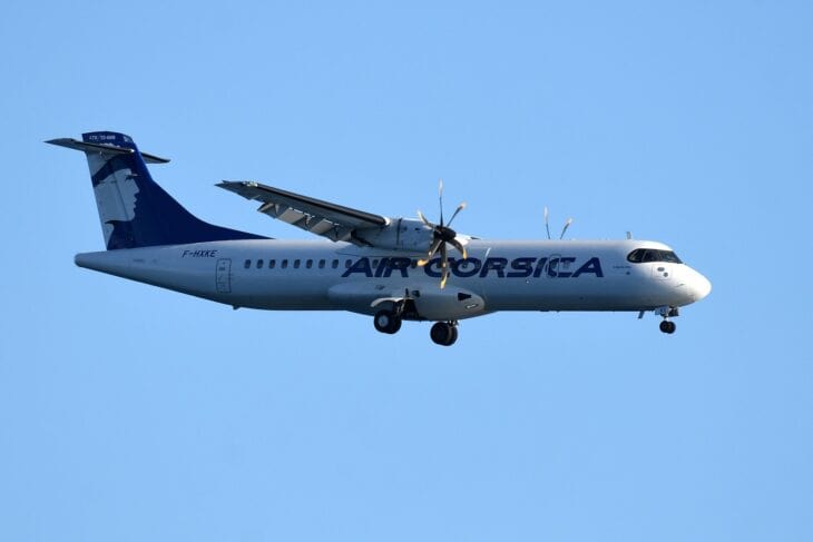 Air Corsica ATR 72-600 F-HXKE in flight with landing gear down against a blue sky
