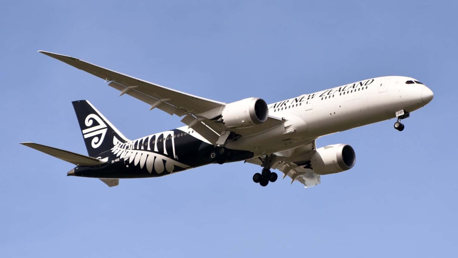 Air New Zealand Boeing 787-9 in the black fern livery climbing out with its landing gear still extended