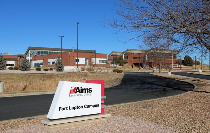 Aims Community College Fort Lupton campus entrance sign with campus buildings behind