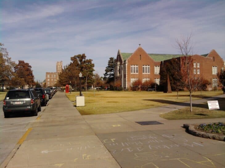 University of Oklahoma campus in Norman with brick collegiate buildings under a blue sky
