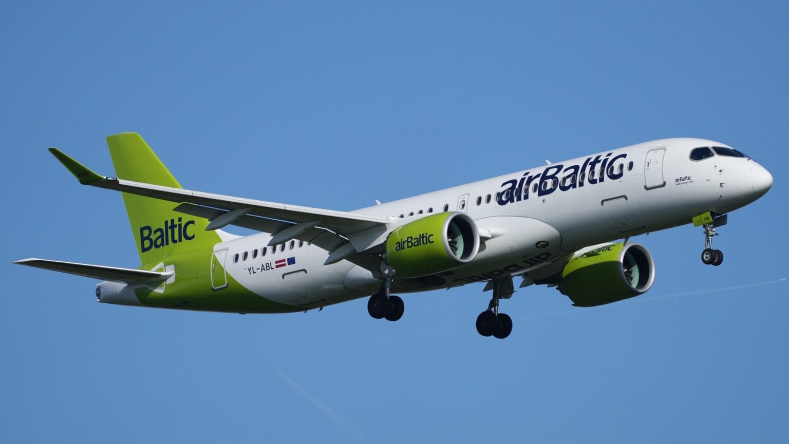 airBaltic Airbus A220-300 YL-ABL on approach with gear down against a blue sky