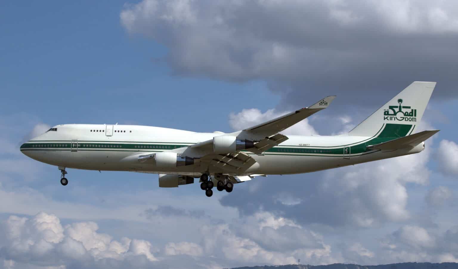 Kingdom Holding Boeing 747-400 HZ-WBT7 on final approach with gear down against a cloudy sky