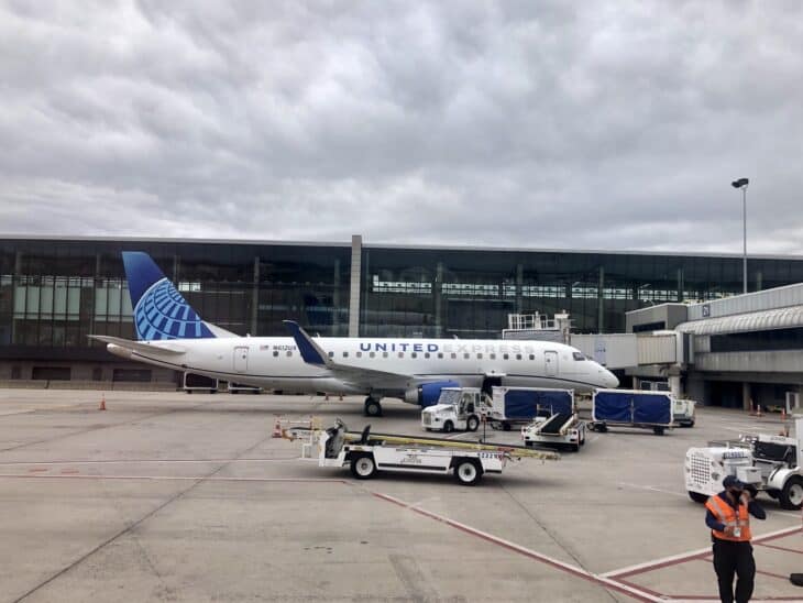 A regional jet parked on the ramp beside the terminal building at Bradley International Airport