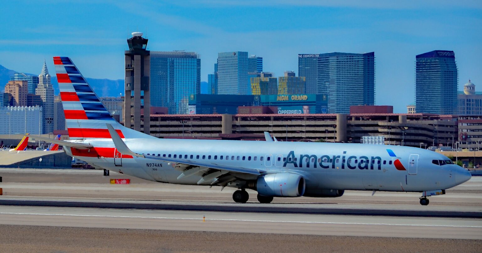American Airlines Boeing 737-800 N974AN taxiing with a city skyline behind