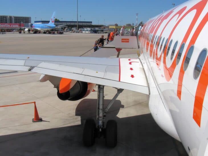 Marked overwing exit escape route on the wing of an easyJet Airbus A319 parked at an airport
