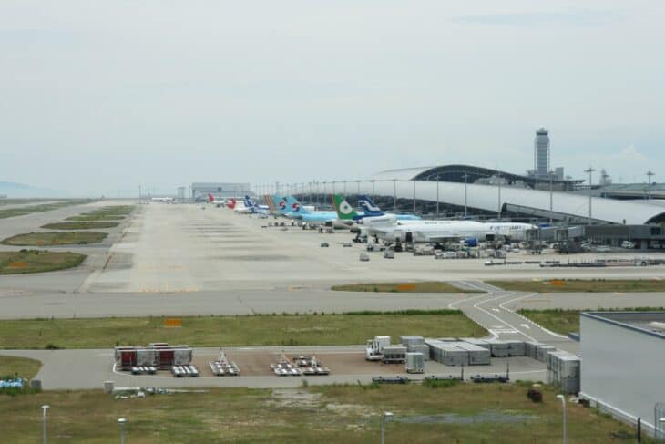 Kansai International Airport apron and terminal seen across the airfield with aircraft parked at the gates
