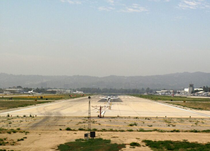 Runway 16R at Van Nuys Airport looking down the pavement toward hazy hills