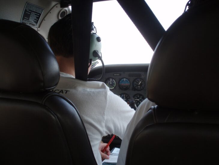 Student pilot seated at the controls of a Cessna 172 training aircraft