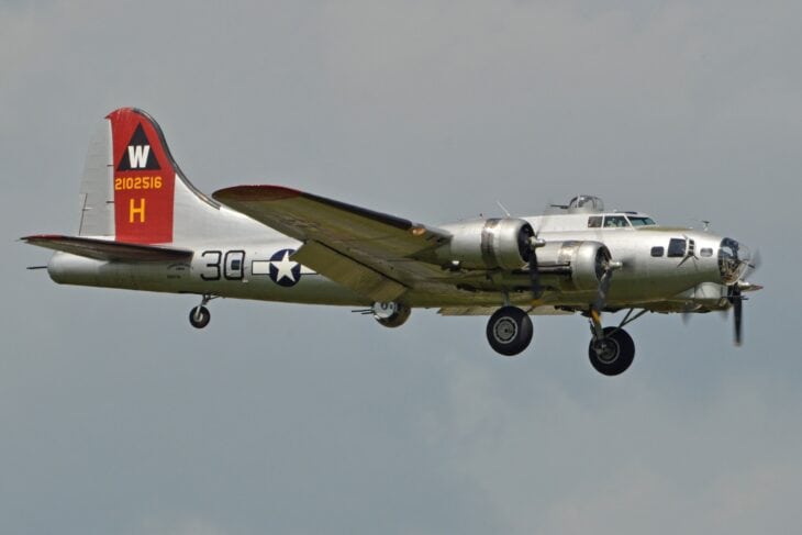 Boeing B-17G Flying Fortress in flight with a red and yellow tail
