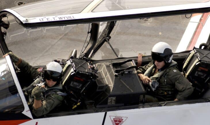 Navy instructor pilot and student in the cockpit of a T-45A Goshawk on a carrier flight deck