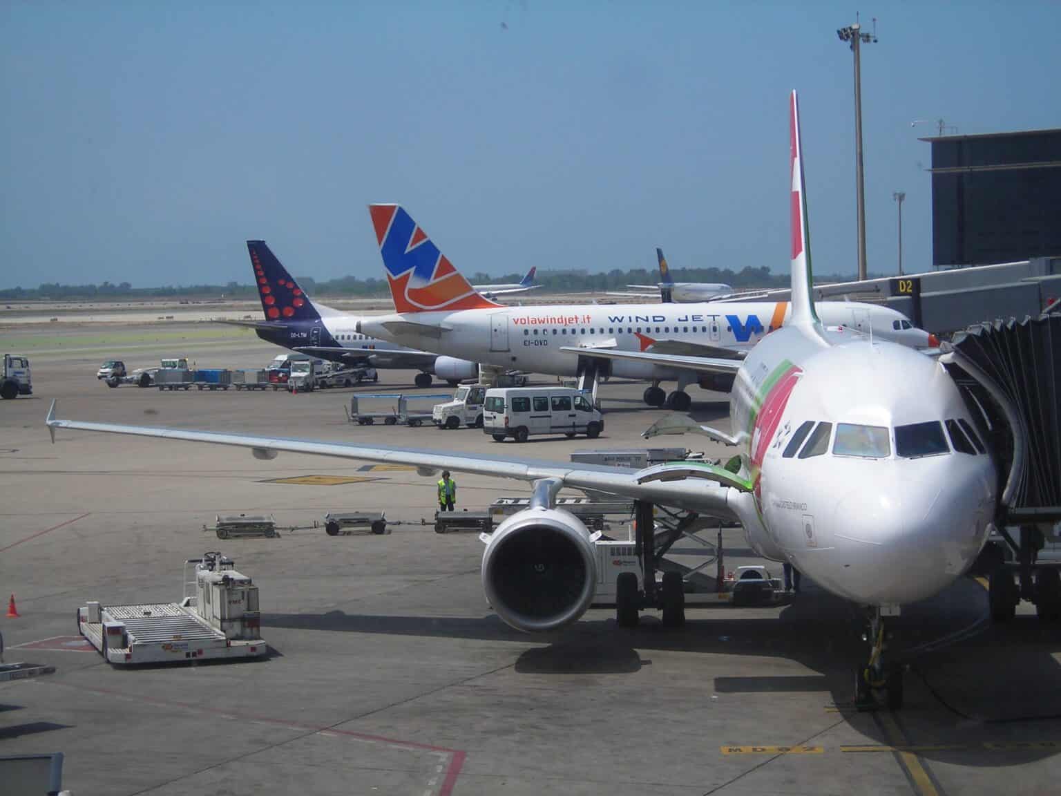 Passenger jets parked at gates on the apron of Barcelona-El Prat airport
