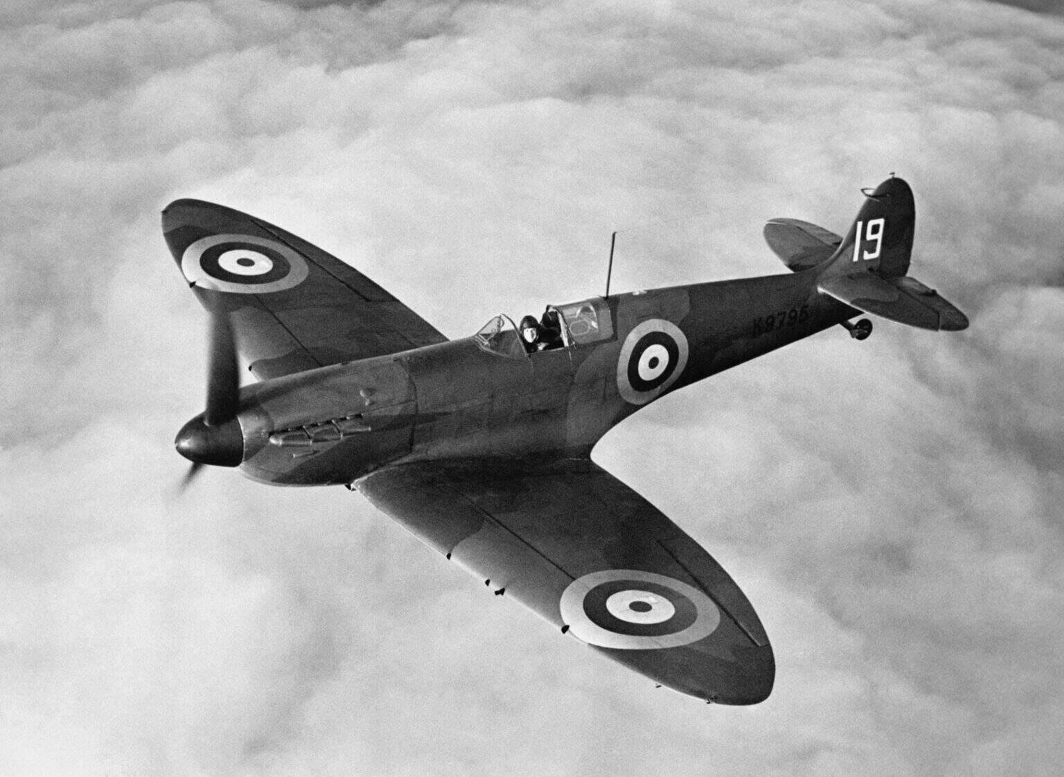 Supermarine Spitfire Mk I K9795 of No. 19 Squadron banking over a cloud layer, black and white
