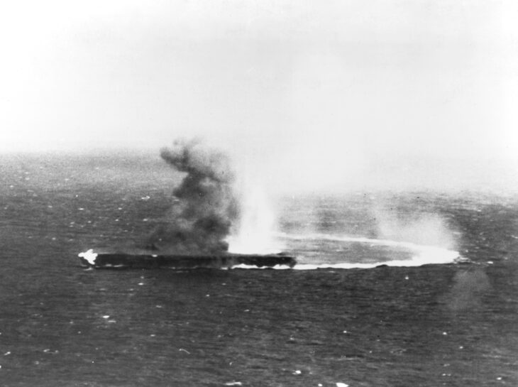 Shokaku under attack by U.S. dive bombers on May 8, 1942, with flames visible on the forecastle