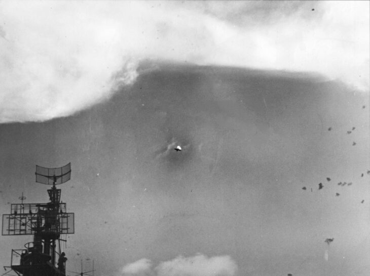 A Japanese plane shot down in the sky over Task Force 58 on June 19, 1944, with the carrier's radar antenna at the left of the frame