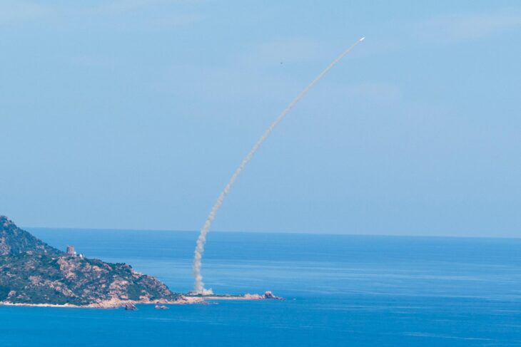 Aster missile trail curving up over the Mediterranean coast after launch from an Italian SAMP/T battery