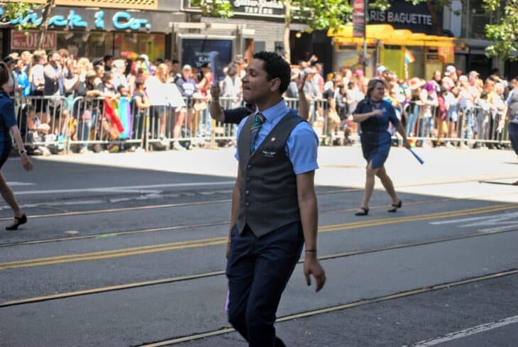 Alaska Airlines flight attendant in uniform walking in the 2022 San Francisco Pride parade