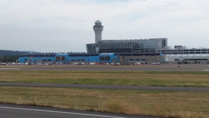 Portland International Airport terminal and control tower seen across the airfield