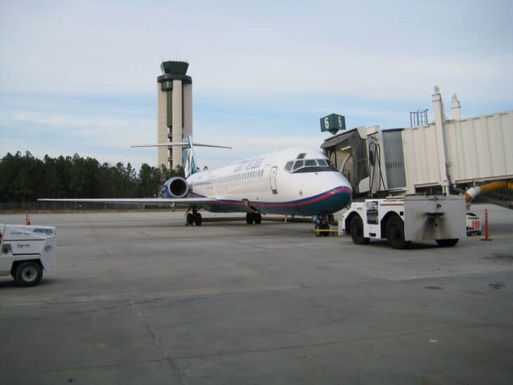 Regional jet parked at the Savannah/Hilton Head terminal beside the control tower