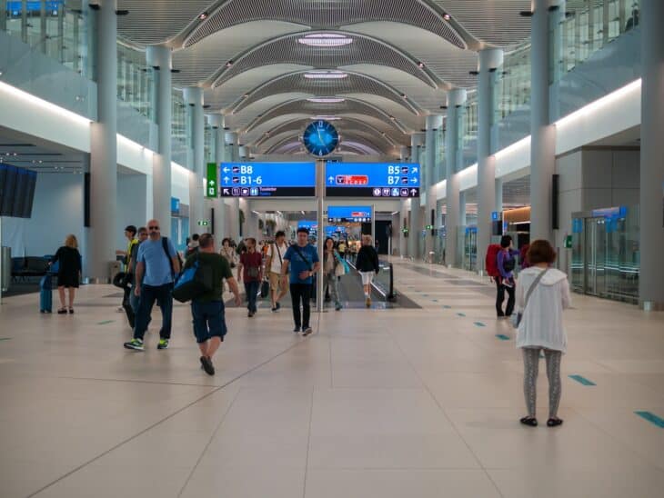 Long concourse inside the new Istanbul Airport terminal with passengers walking toward the gates