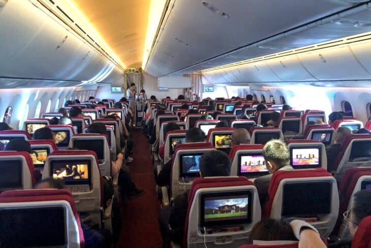 Hainan Airlines Boeing 787-9 economy cabin B-6969 with red seats and seatback screens