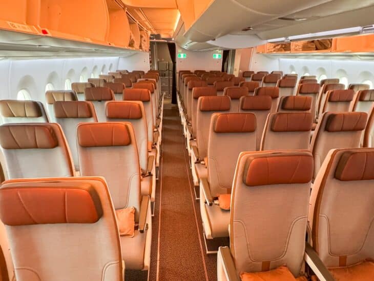 STARLUX Airlines Airbus A350-900 economy cabin with orange and tan seats before departure