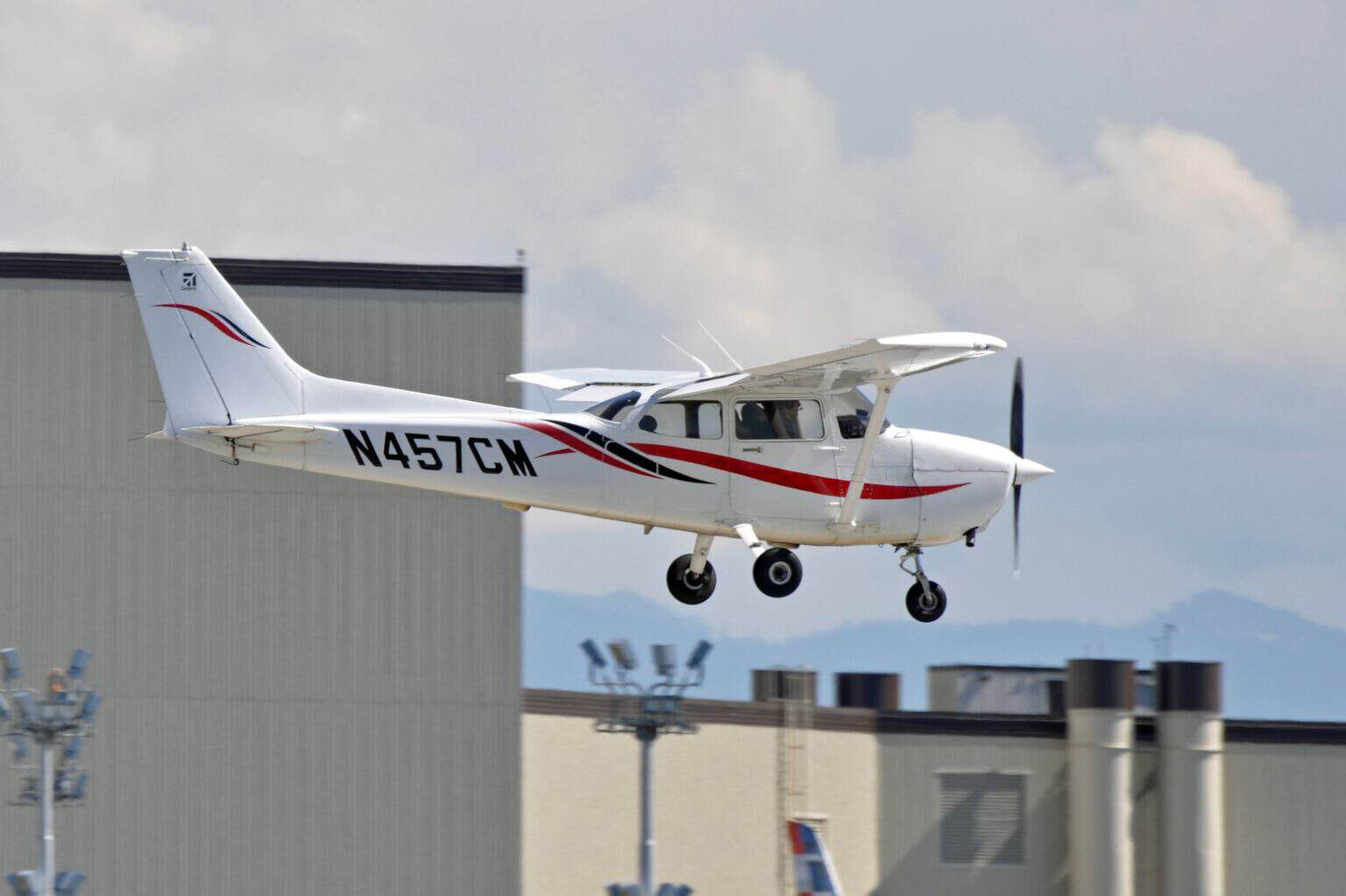 Cessna 172 Skyhawk N457CM on short final with flaps extended, a typical primary trainer