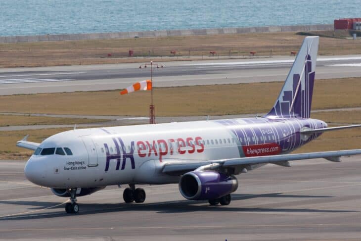 HK Express Airbus A320-232 B-LCA in purple and white livery on the ground