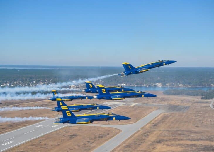 Six Blue Angels Super Hornets in a pitch-up break over the Florida coast