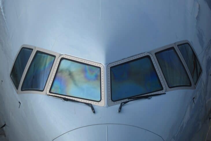 Close-up of the flight deck windshields and side windows on the nose of an American Airlines Boeing 777-300ER