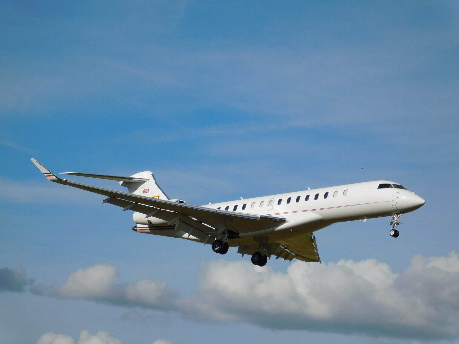 Bombardier Global 7500 M-JCBB airborne at Oxford Airport with its landing gear down