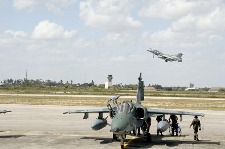 Brazilian Air Force AMX A-1M parked on the ramp with a Mirage 2000 departing behind it