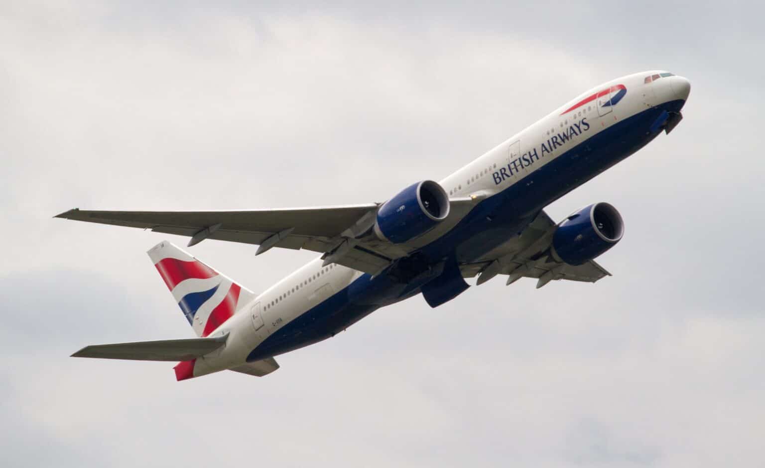 British Airways Boeing 777-200ER G-VIIA climbing steeply after takeoff with its landing gear retracting