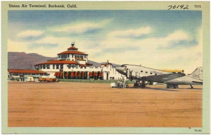 Vintage postcard of the Union Air Terminal at Burbank with an airliner parked on the ramp