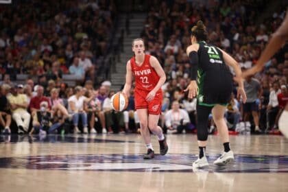 Caitlin Clark of the Indiana Fever dribbling the ball up court against the Minnesota Lynx
