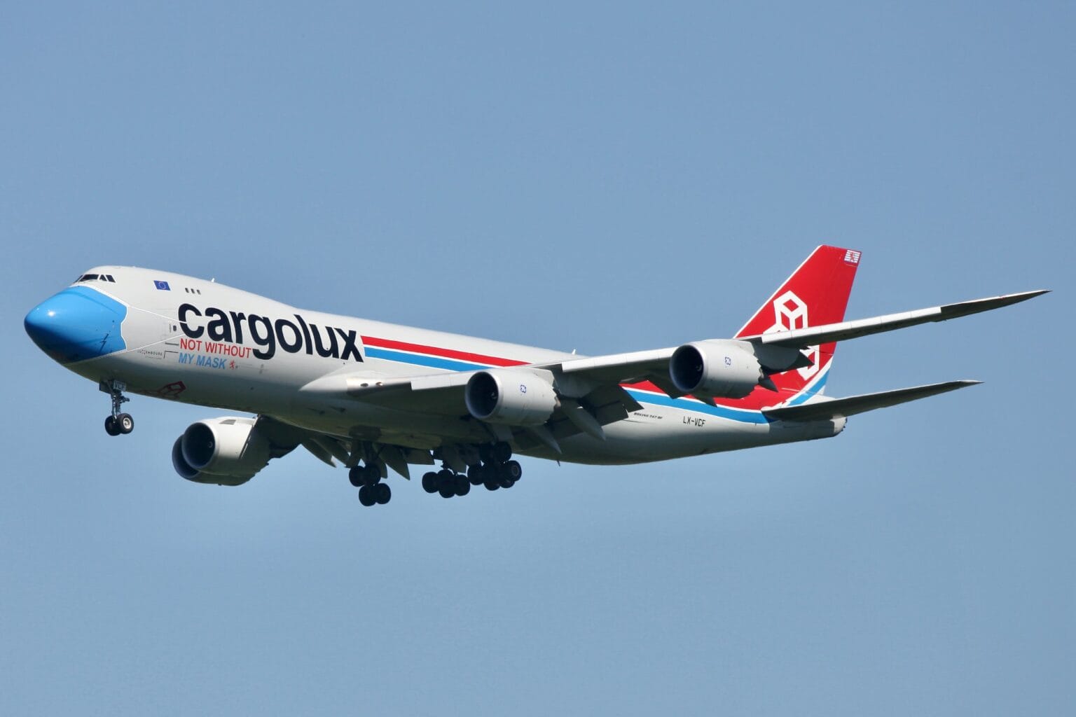 Cargolux Boeing 747-8F LX-VCF on approach with its gear down, wearing the blue face-mask nose livery