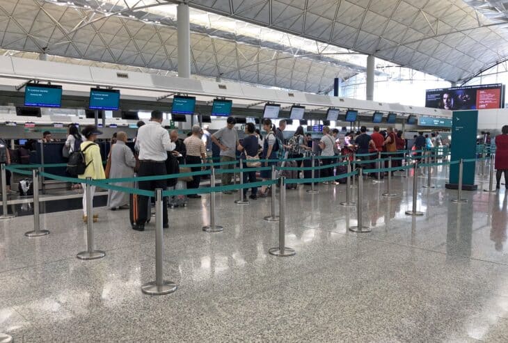 Passengers queue at Cathay Pacific check-in counters in Hong Kong International Airport Terminal 1