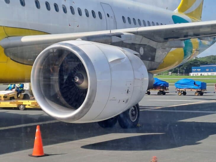 Close view of a CFM56-5B turbofan engine inlet under the wing of an Airbus narrowbody at Manila airport