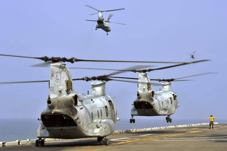 Two CH-46E Sea Knight helicopters lifting off from the flight deck of the amphibious assault ship USS Bonhomme Richard