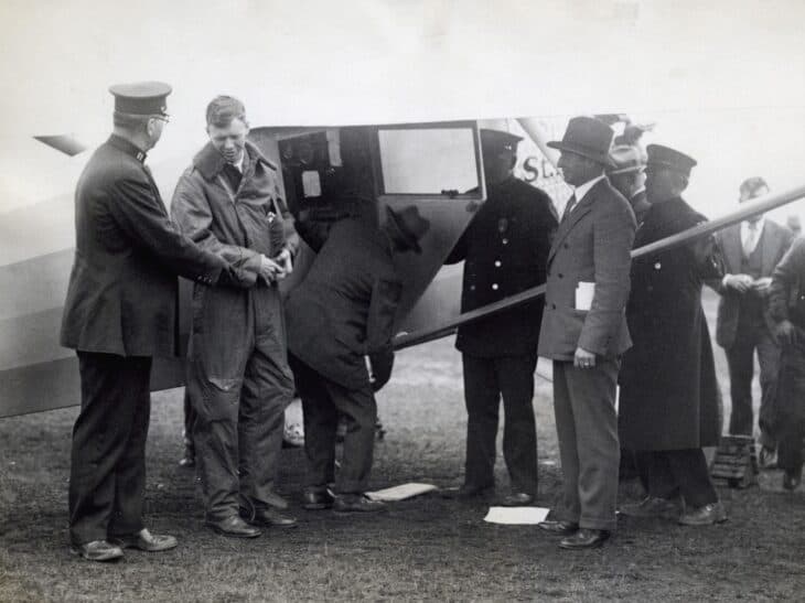 Charles Lindbergh shaking hands beside the Spirit of St. Louis before departure in May 1927
