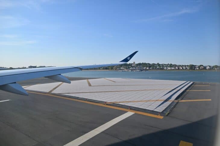 EMAS arrestor bed beside Runway 22R at Boston Logan with a JetBlue jet's wing in the frame