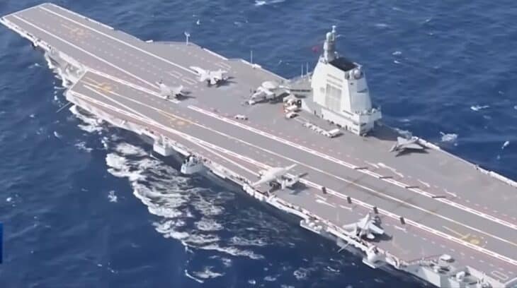Aerial view of the Chinese aircraft carrier Fujian at sea with aircraft on the flight deck